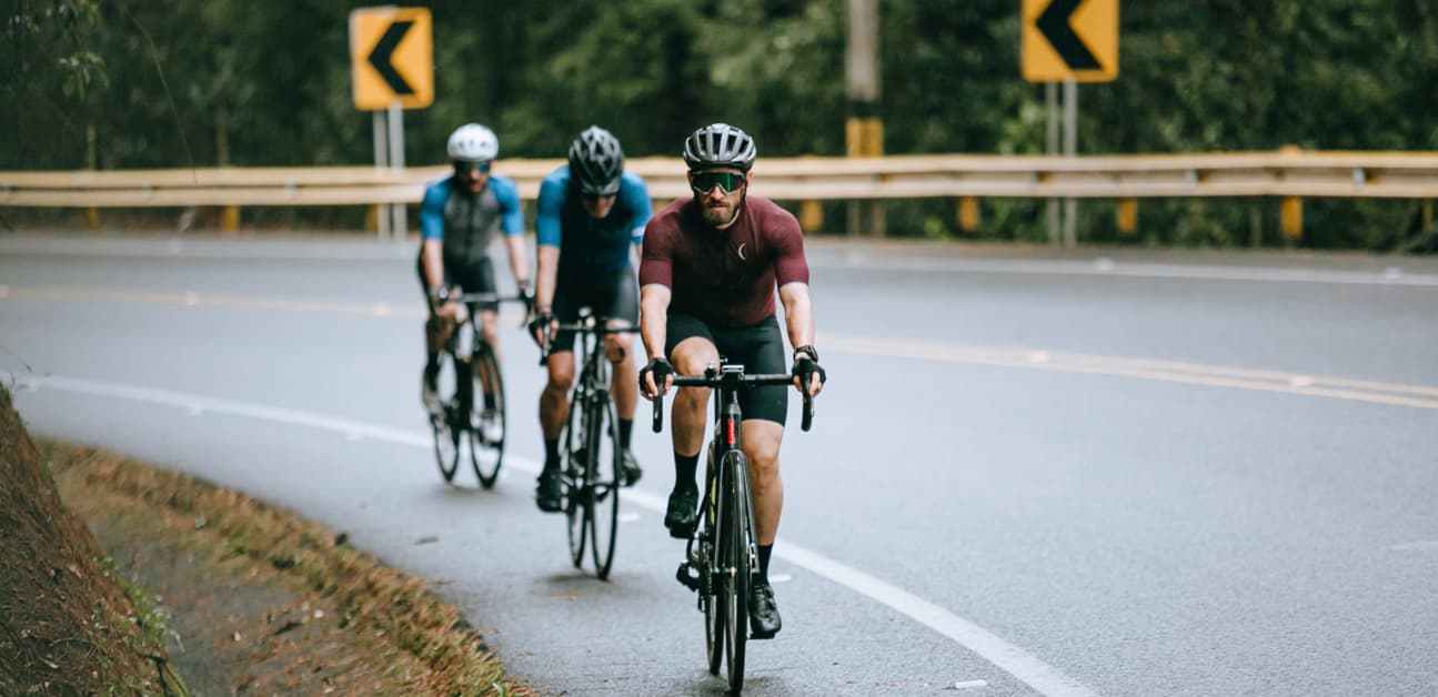 three cyclists riding in a group